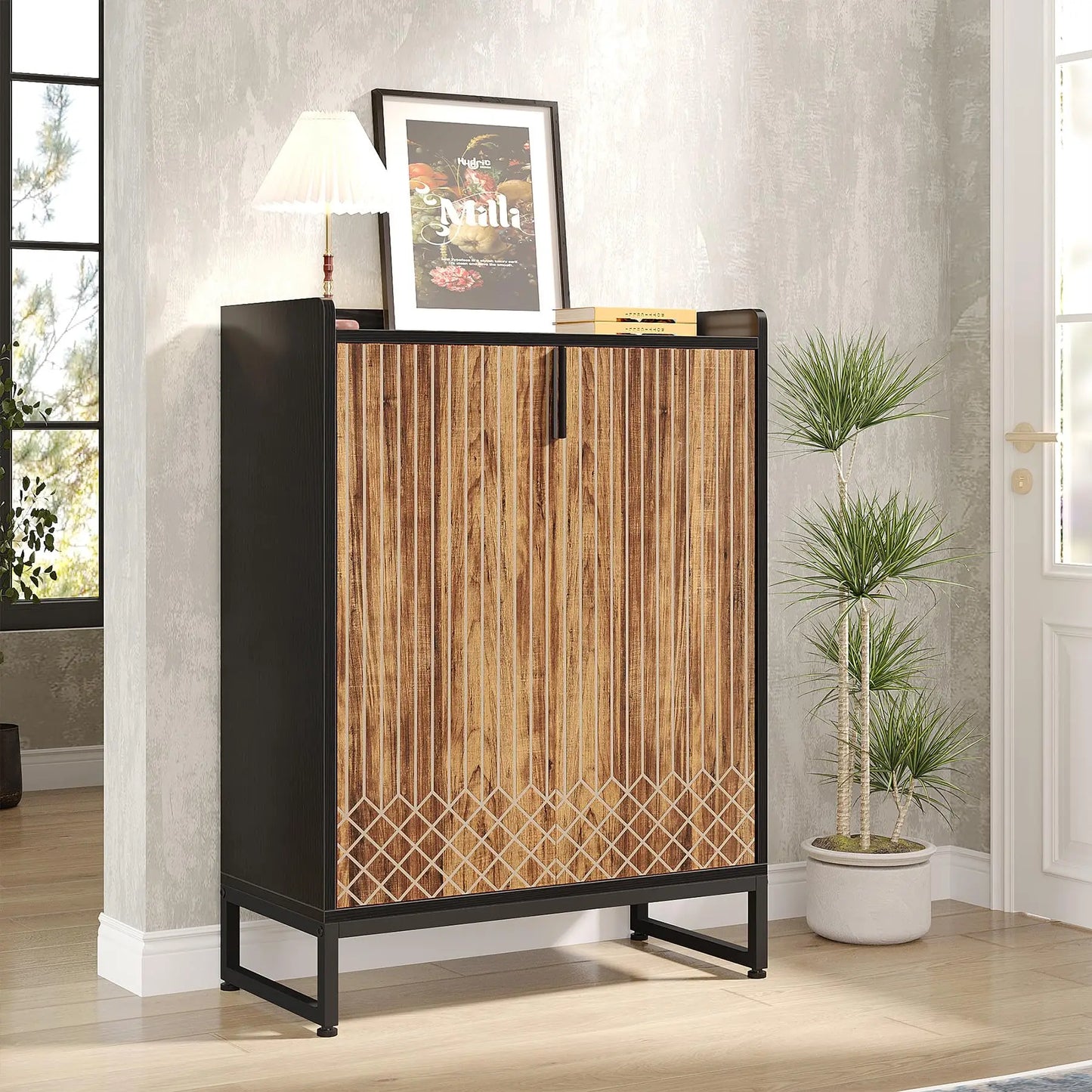 Wooden cabinet with black metal frame in a room with a plant and framed picture.