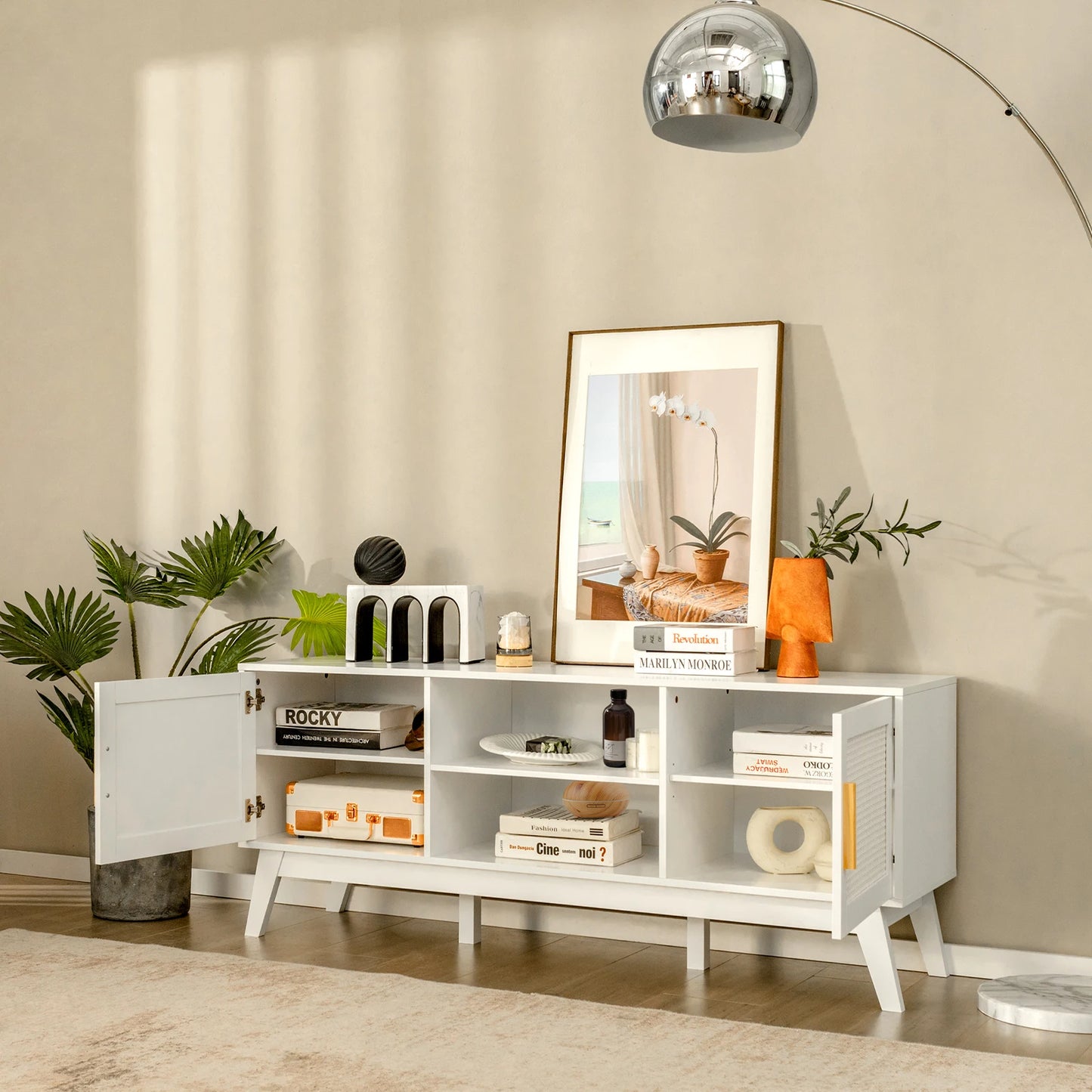 White entertainment console Rattan TV Stand with decorative items in a living room setting