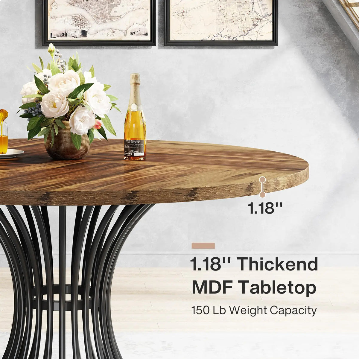 Round wooden table with black metal legs, featuring a bottle of champagne and flowers on the surface.
