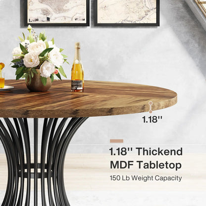 Round wooden table with black metal legs, featuring a bottle of champagne and flowers on the surface.