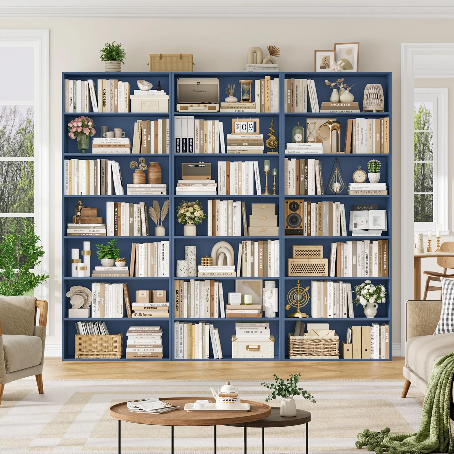 Navy blue bookshelf filled with books and decorative items in a living room setting.