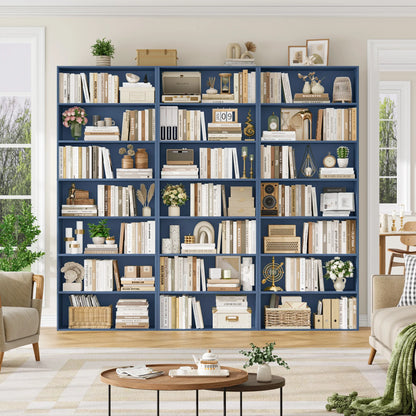 Navy blue bookshelf filled with books and decorative items in a living room setting.