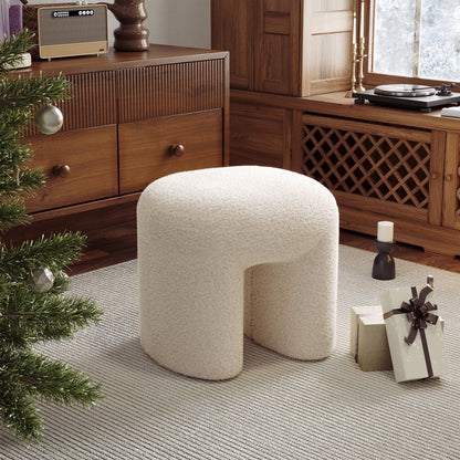Beige / white ottoman in a room with wooden furniture and a Christmas tree.