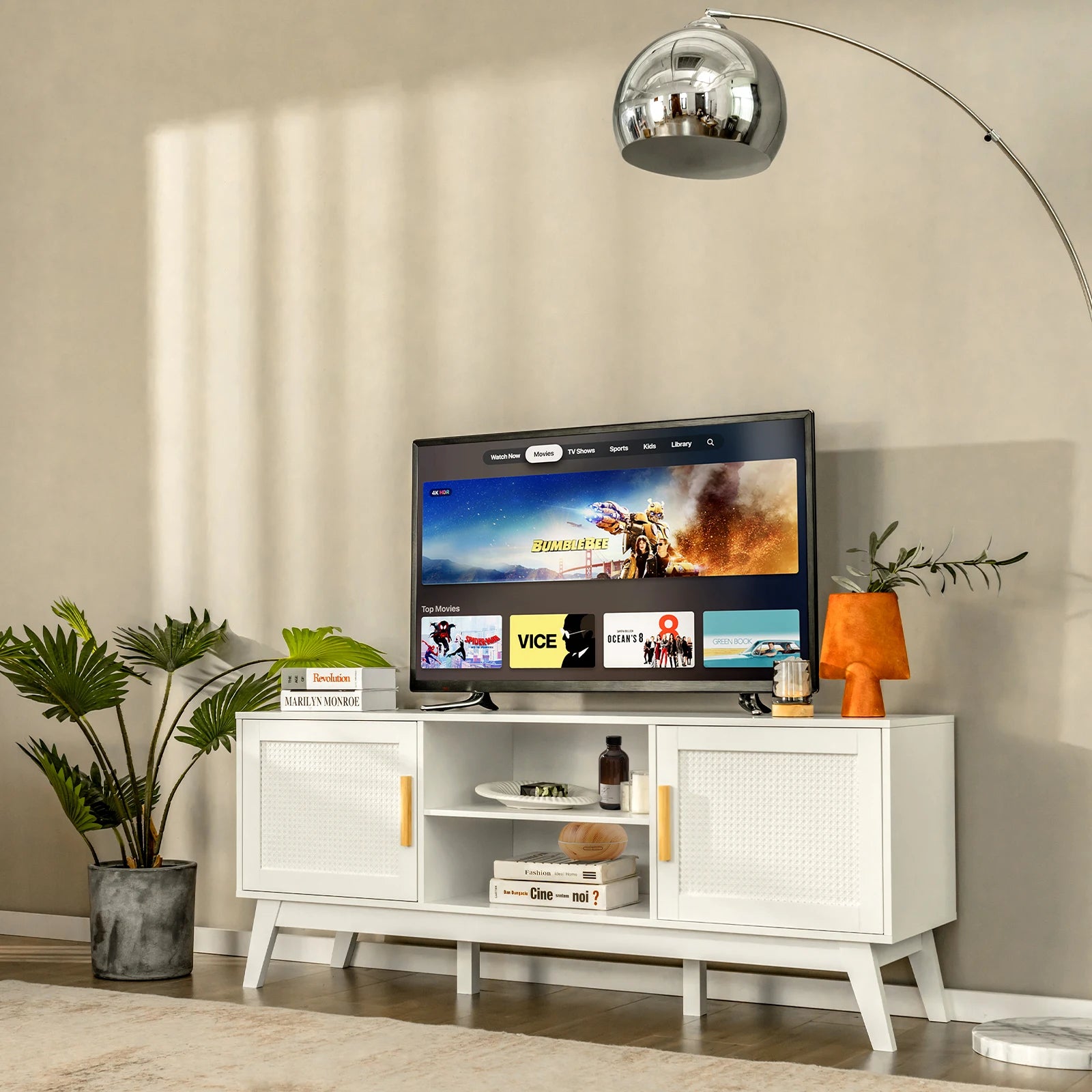 Modern living room with a Modern White Rattan TV Stand, plants, and a lamp.