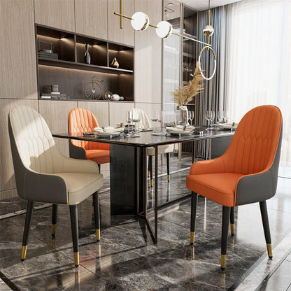 Modern dining room with a black marble table and colorful chairs.