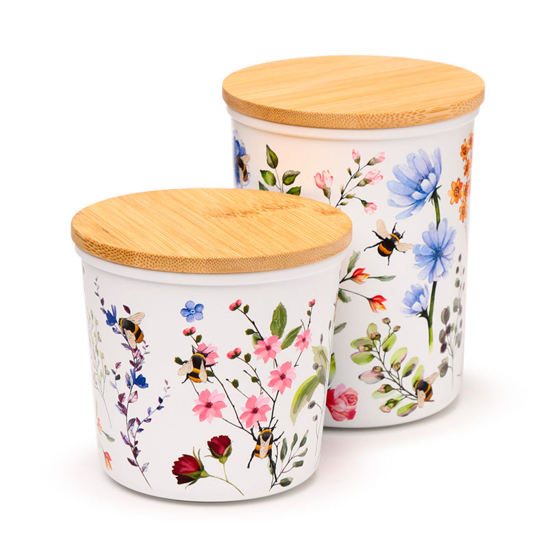Two storage jars with floral patterns, one small and one medium, both with bamboo lids.