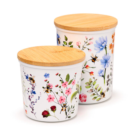 Two storage jars with floral patterns, one small and one medium, both with bamboo lids.