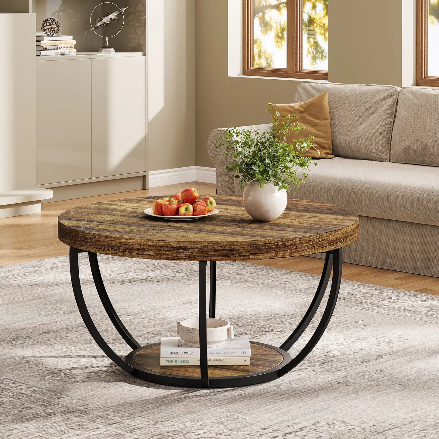 Riota Round wooden coffee table with metal legs in a living room setting.