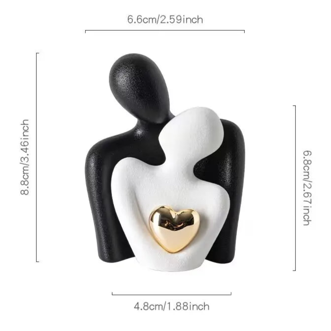 Black and white sculpture of two figures holding a gold heart with dimensions and weight displayed.