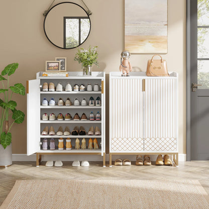 White shoe cabinet with open doors displaying shoes, placed in a room with decor elements.