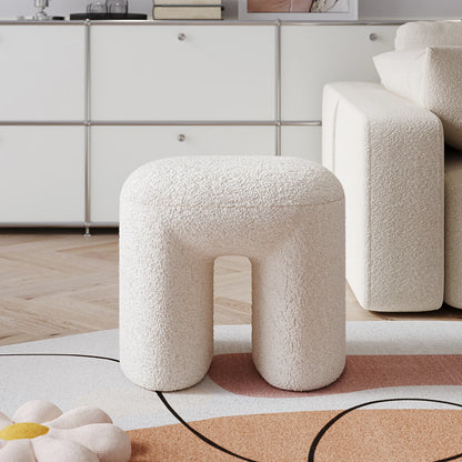 White teddy textured stool in a modern living room setting with a neutral color palette.