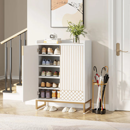 White shoe cabinet with open doors displaying shoes, next to a gold umbrella stand with umbrellas in a room.