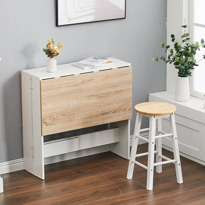 Wooden fold-out table in a room with a stool and decor items.