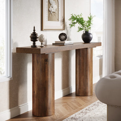 Wooden console table with decorative items in a room with a window and chair.