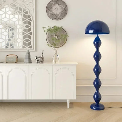 Blue floor lamp in a room with white cabinet and decorative items