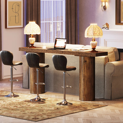 Modern living room with wooden bar table, leather stools, and a laptop.